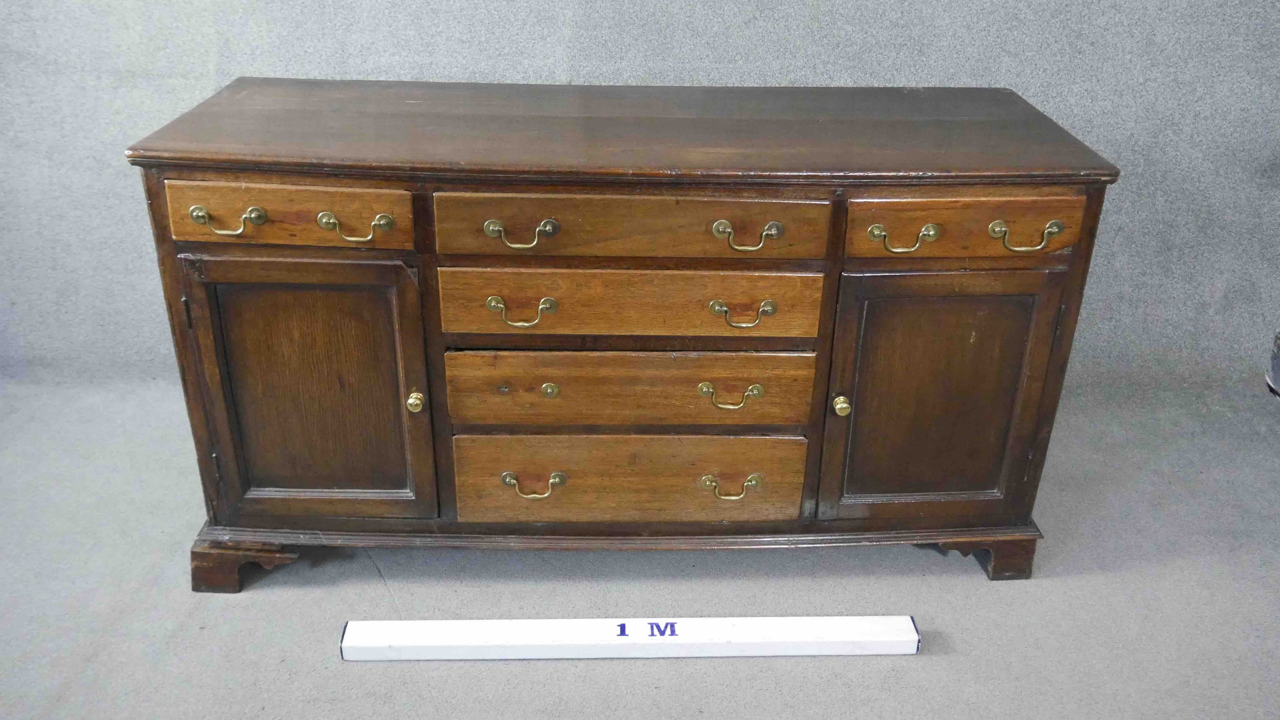 A Georgian country oak dresser base fitted with central drawers with brass swan neck handles flanked - Image 2 of 7