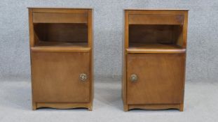 A pair of mid century walnut Art Deco style bedside cabinets. H.60 W.37 D.28 cm
