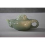 A Chinese 20th century carved jade lidded teapot with cherry blossom detailing and branch form