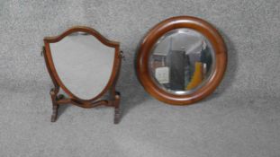 A 19th century mahogany swing frame toilet mirror and a bevelled circular wall mirror. H.42 W.30cm (