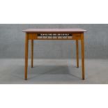 A vintage beech kitchen table with composite laminated gingham check top on shaped splay tapering