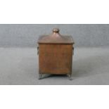 An early 20th century lantern shaped hammered copper coal box with scrolling design brass handles