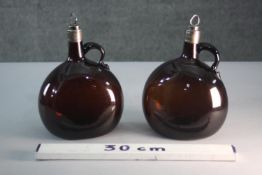 A pair of Victorian amber glass onion flagons with silver collar and silver topped cork stopper.