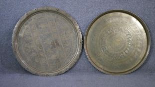 Two engraved Indian brass circular serving trays decorated with elephants, Buddhas and