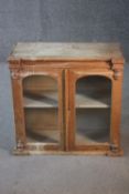 A 19th century pine hanging cabinet with glazed arched panel doors. H.63 W.64 D.26 cm.