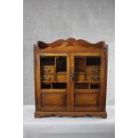 A 19th century oak table cabinet with glazed doors enclosing fitted interior on shaped bracket feet.