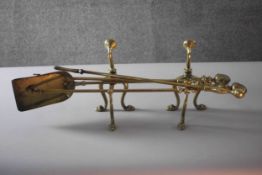 A pair of Victorian brass fire dogs with lion paw feet along with brass fire irons. (5 pcs) 68cm(