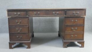 A Georgian style mahogany three part pedestal desk. H.98 W.150 D.90cm