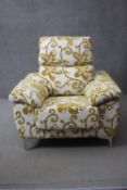 A contemporary floral upholstered armchair on shaped brushed chromium supports by Acomodel. H.100