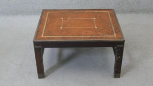 A Georgian mahogany military style brass bound low table with inset gilt tooled leather top on