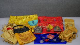 A collection of Tibetan silk bags and Buddhist items along with Native American suede bags with