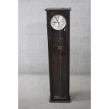 A walnut cased Synchronome electric master wall clock with silvered dial, accompanied by pendulum