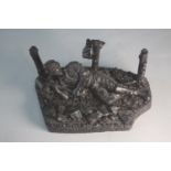 A carved coal figure of a coal miner at work. H.17 W.11cm.