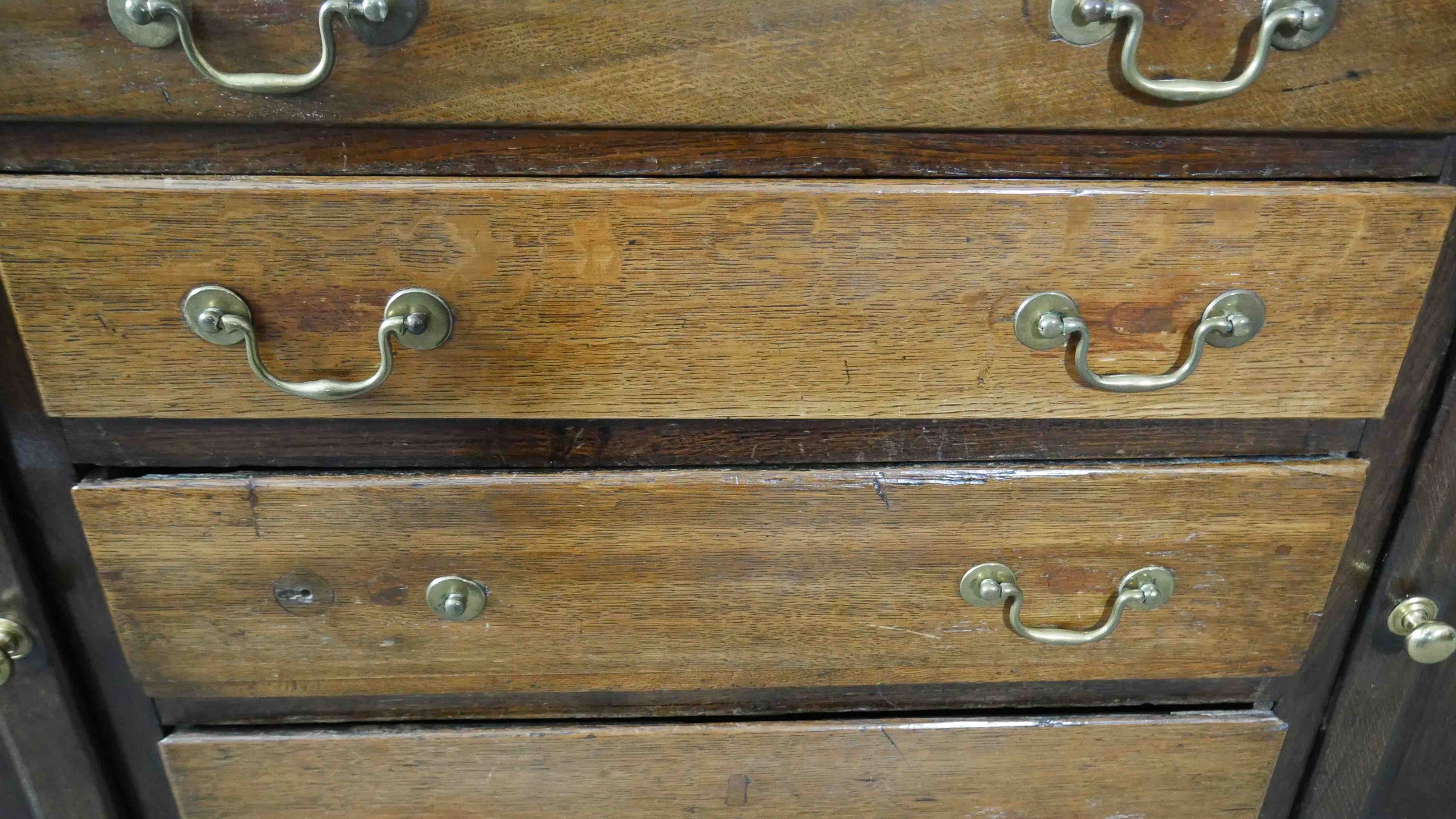 A Georgian country oak dresser base fitted with central drawers with brass swan neck handles flanked - Image 6 of 7
