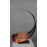 A large copper effect abstract curl steel sculpture on rectangular base. Indistinctly signed and