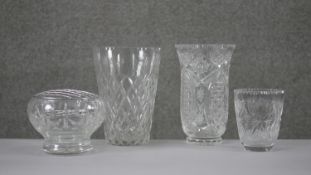 A collection of four cut crystal flower vases with stylised foliate design. H.20 Diam.15cm (largest)