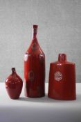 A miscellaneous collection of three red vases. Including a Chinese style lacquered vase inlaid