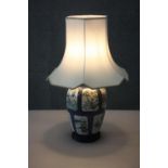 A Chinese Kangxi hand painted porcelain vase converted to a lamp on carved and pierced hardwood