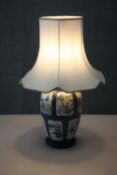 A Chinese Kangxi hand painted porcelain vase converted to a lamp on carved and pierced hardwood