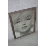 A framed mirrored panel with black and white transfer print of Marilyn Monroe. H.70 W.52cm.