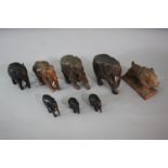 Eight carved animals. Including seven elephants some ebony and a Blackforest wild boar. H.13 W.12