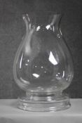 A large contemporary blown clear glass storm lantern with removable base. (2 pieces) H.46 Diameter.