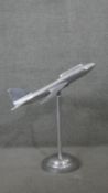 A large chrome model of a vintage style passenger jet on circular stand. H.78 W.68 D.68cm