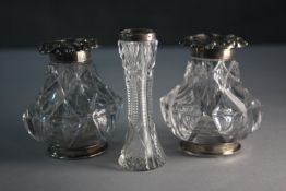 A 19th century cut glass and silver topped ink well and pounce pot with repousse detailing along