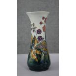A Moorcroft vase with tube lined blackberry and bramble decoration and impressed makers marks to