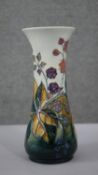 A Moorcroft vase with tube lined blackberry and bramble decoration and impressed makers marks to
