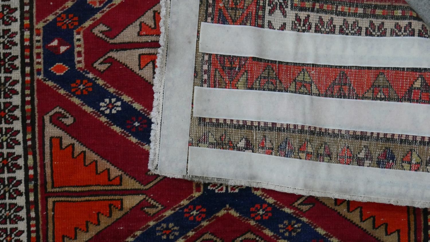 A Persian Heriz runner with repeating hooked lozenge medallions within geometric borders. L.315 W. - Image 5 of 5