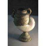 An Asian pearl nautilus shell and brass water jug with engraved detailing. (shell damaged) H.26 W.17