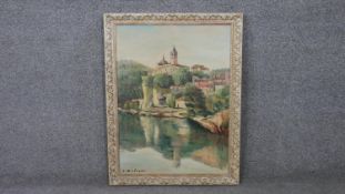 A framed oil on canvas of a riverside chateau. Signed R. Solier. H.69 D.53cm