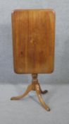 A 19th century mahogany tilt top table on baluster turned pedestal base with swept supports. H.72