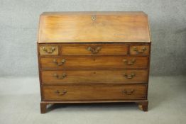 A Georgian mahogany bureau with fall front revealing satinwood and olivewood inlaid interior above