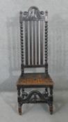 A late 19th century oak Carolean style side chair with scrolling foliate carved cresting to the back