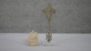 An Ethiopian silver plate Coptic pierced design hand cross on clear display stand along with a