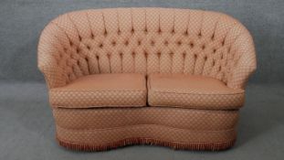 A 19th century style two seater sofa in deep buttoned geometric design upholstery. H.78 W.140 D.75CM