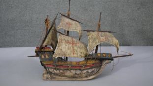 A 20th century painted wooden model of a three mast sailing galleon with shield and red cross