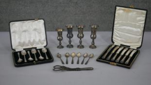 A collection of silver. Including a cased set of silver coffee spoons, a set of silver handled