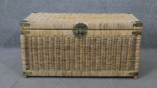 A Chinese wicker chest with central partition and engraved brass fittings. H.41 W.81 D.41cm