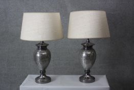 A pair of crackle mirrored grey glass urn design table lamps with cream shades. H.74 Diameter 18 cm.