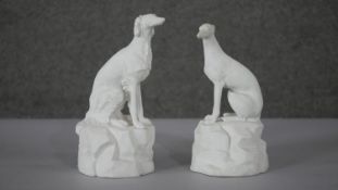 Two 19th century Parianware style dogs on rock formation bases. One of a Greyhound and one of a