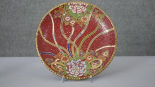 A 20th century Japanese Satsuma ware plate. Decorated with a stylised floral design with gilded
