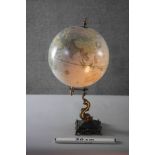 A Victorian style globe on brass dolphin design stand. H.53 Diameter.29cm.