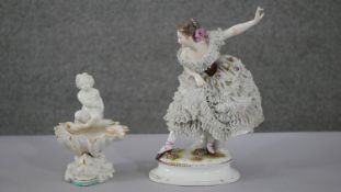 Two porcelain figures. A 19th century Dresden hand painted ballet dancer with porcelain lace