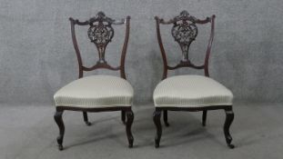 A pair of late 19th century carved mahogany bedroom chairs.