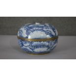 A Thai hand painted blue and white enamel on brass lidded box with lotus leaf and pod design.