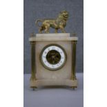 A 19th century alabaster and gilt spelter mantle clock. Lion to the top and exposed skeleton