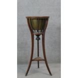 A 19th century mahogany jardiniere stand with brass liner on swept supports. H.90 Diam.37 cm (